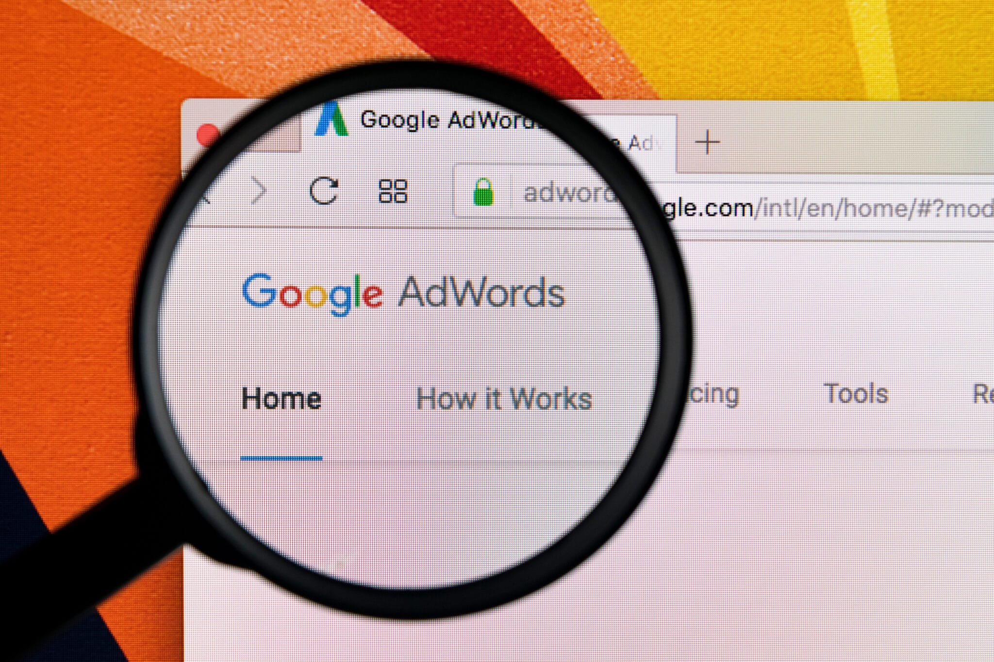 Adwords management agency new hampshire photo with a magnifying glass over the words "google adwords"