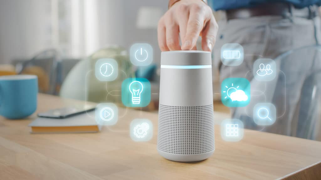 HeartBeep Marketing NH Intent Based Marketing, Man Turns On Smart Speaker with Active Artificial Intelligence Assistant with Futuristic Screenless Interface with Different Icons and Symbols.