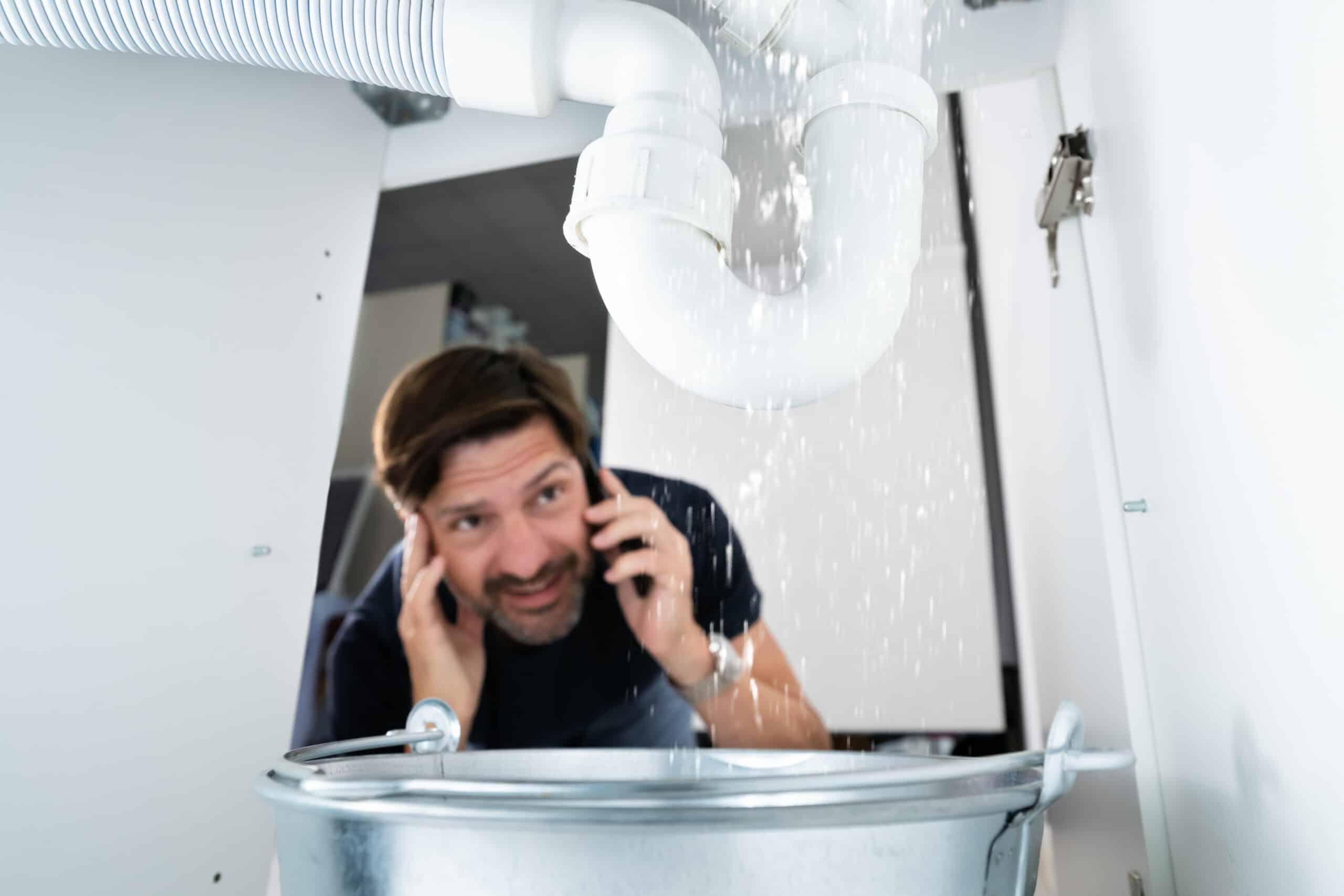 HeartBeep Marketing NH Intent Based Marketing, Worried Man Calling Plumber While Watching Water Leaking From Sink